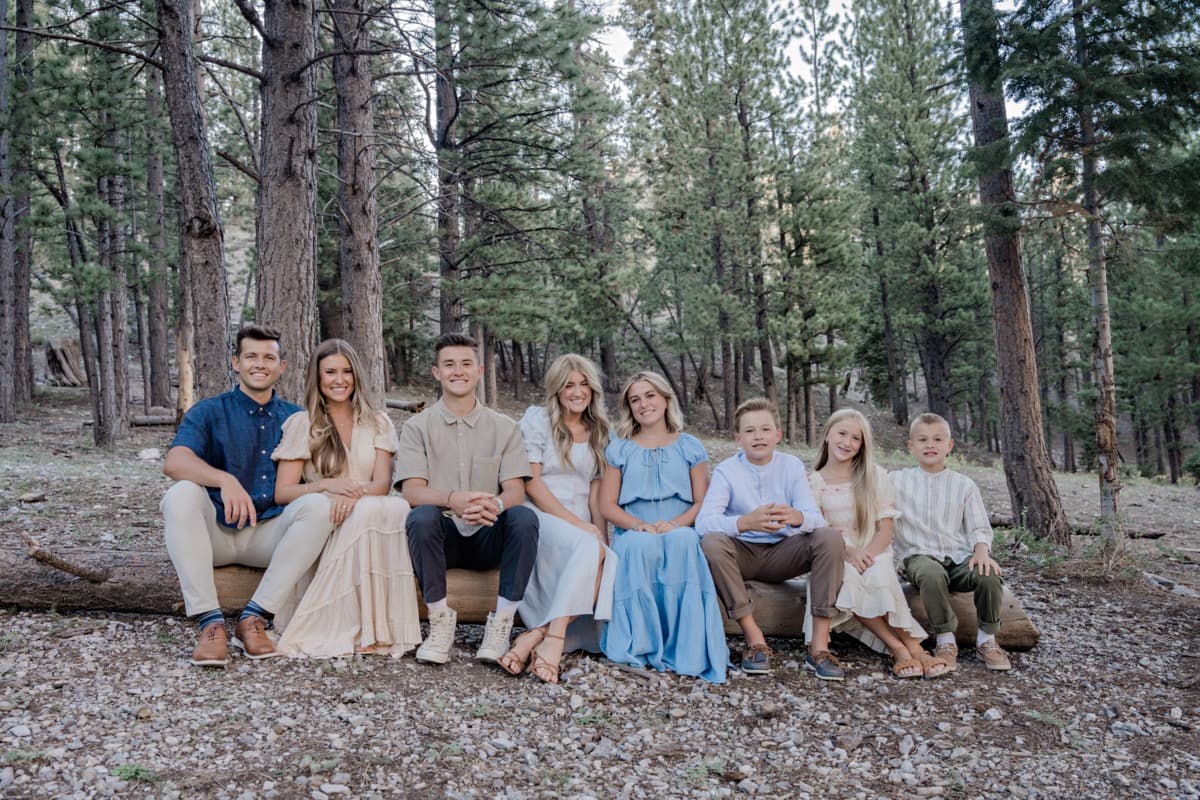 Large family seated on a log at Mt Charleston