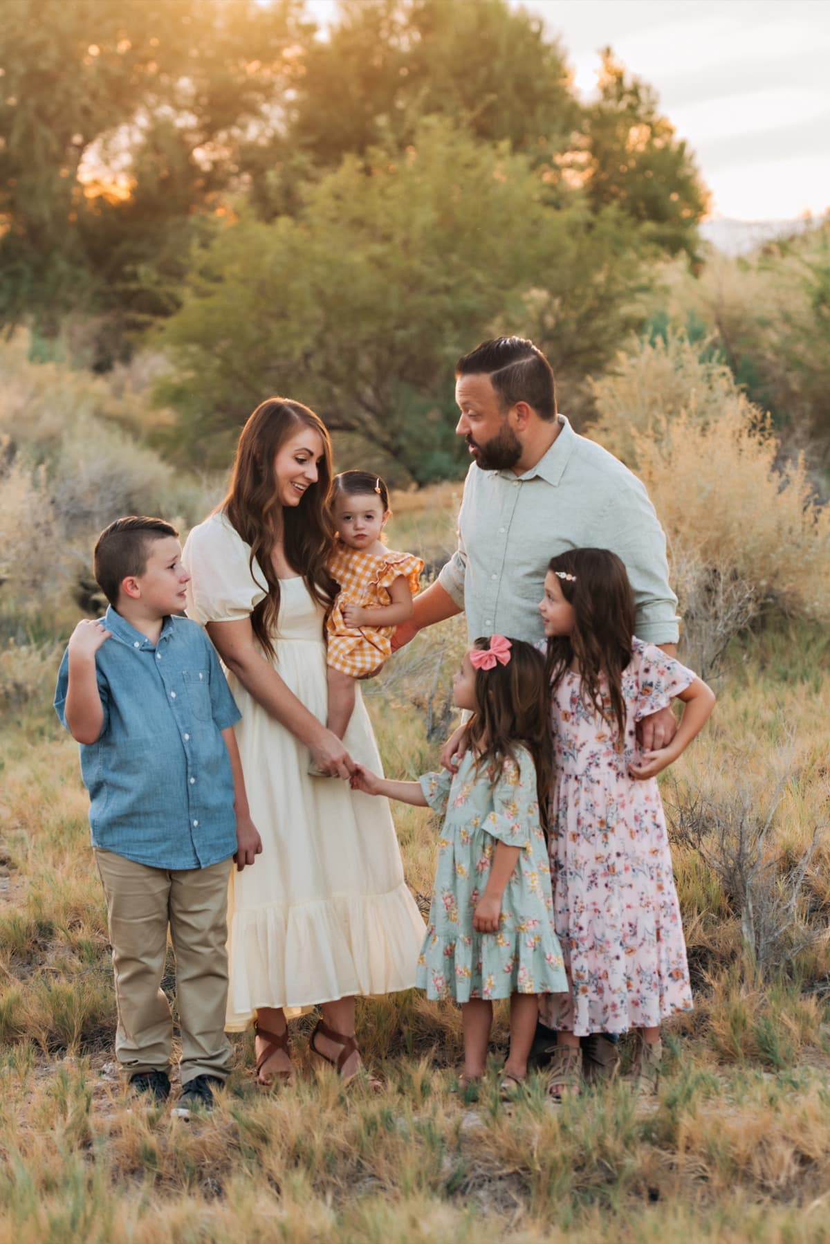 Family of six among aspens at golden hour