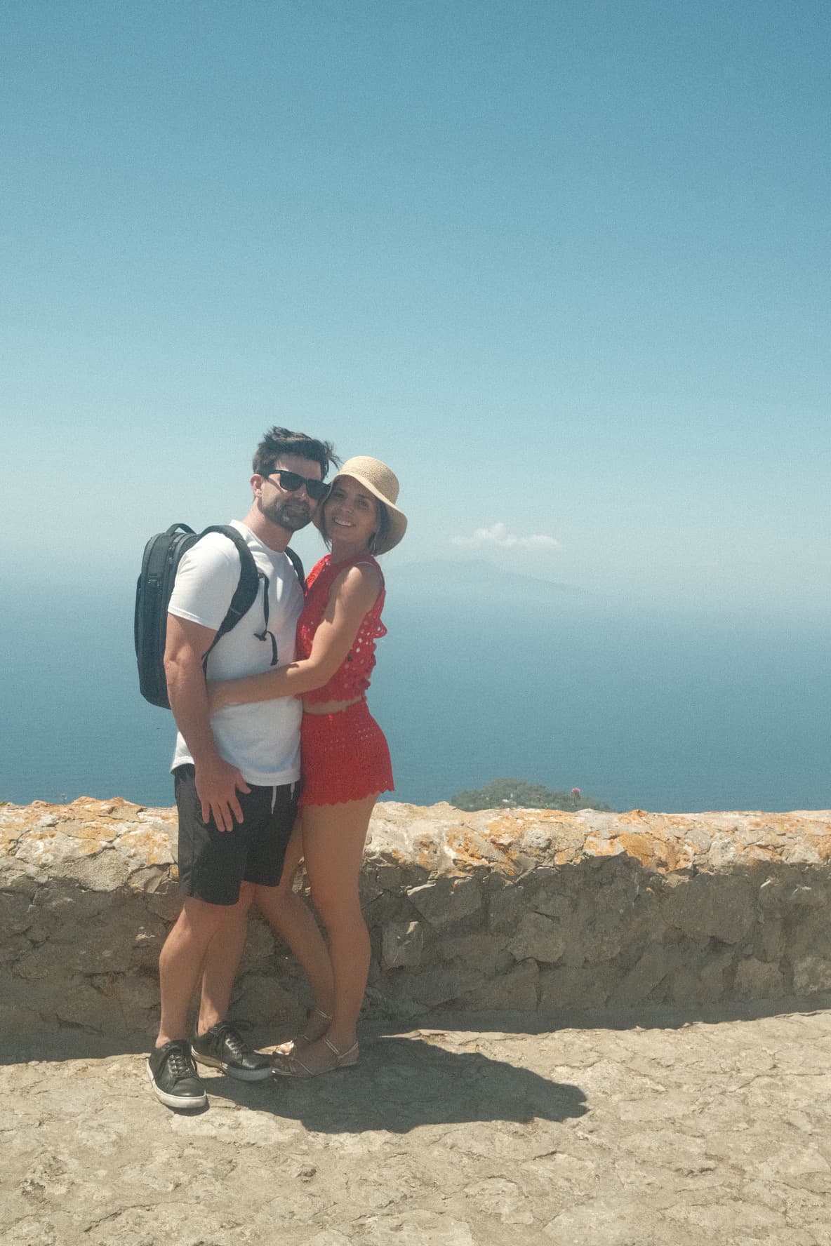 Jennie traveling with her partner overlooking the ocean