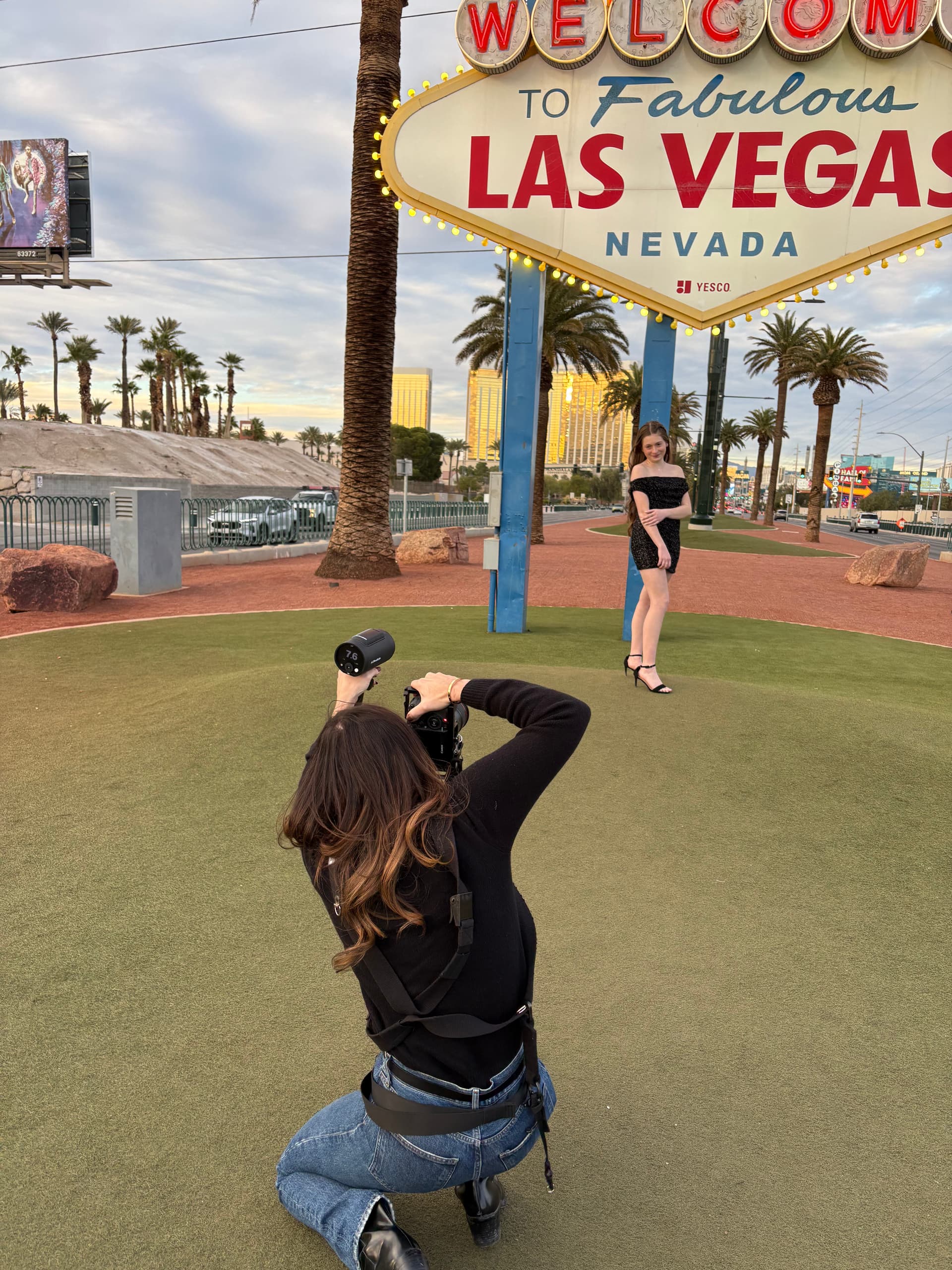 Jennie photographing a client at the Welcome to Las Vegas sign