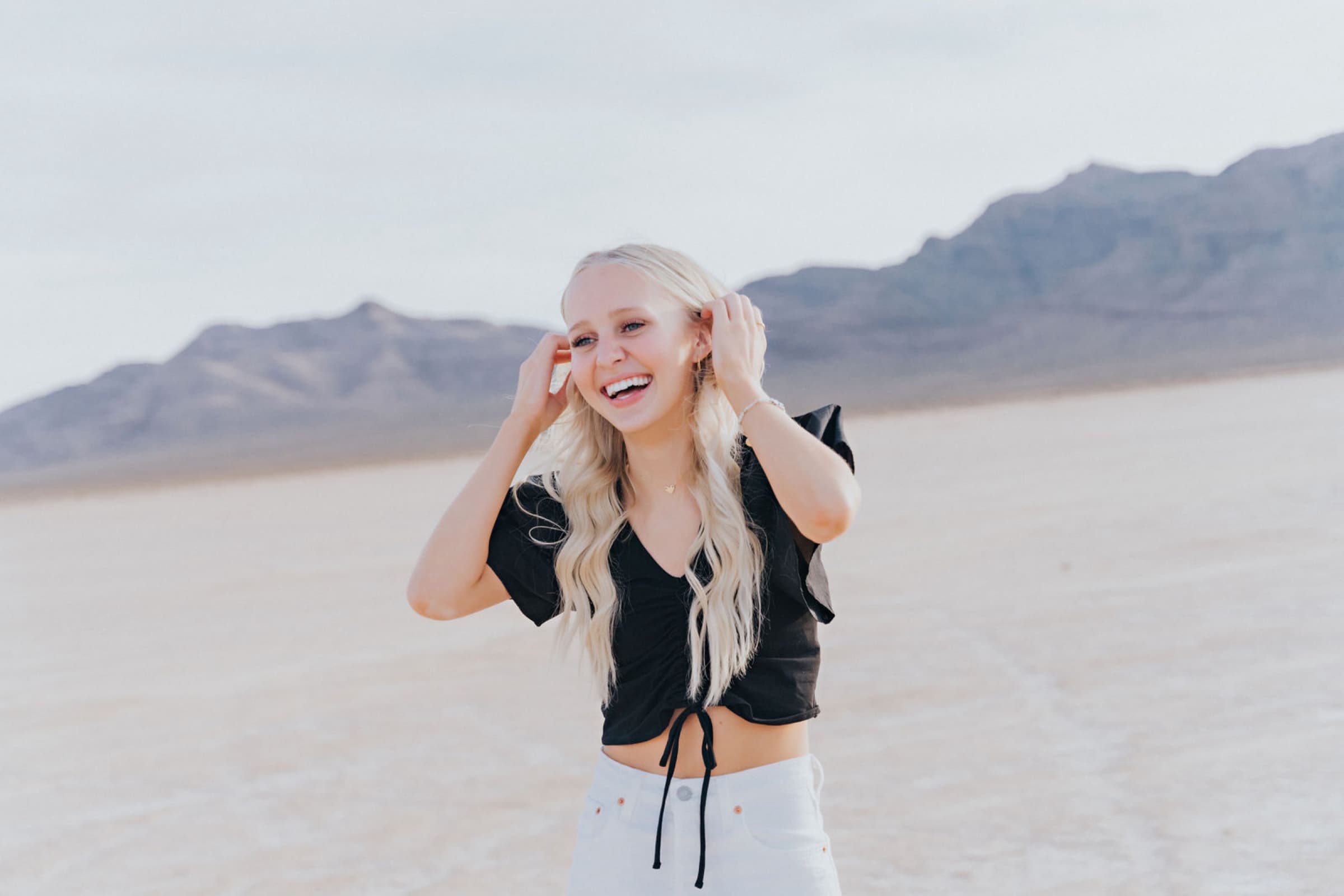 Senior girl black top white shorts Dry Lake Bed