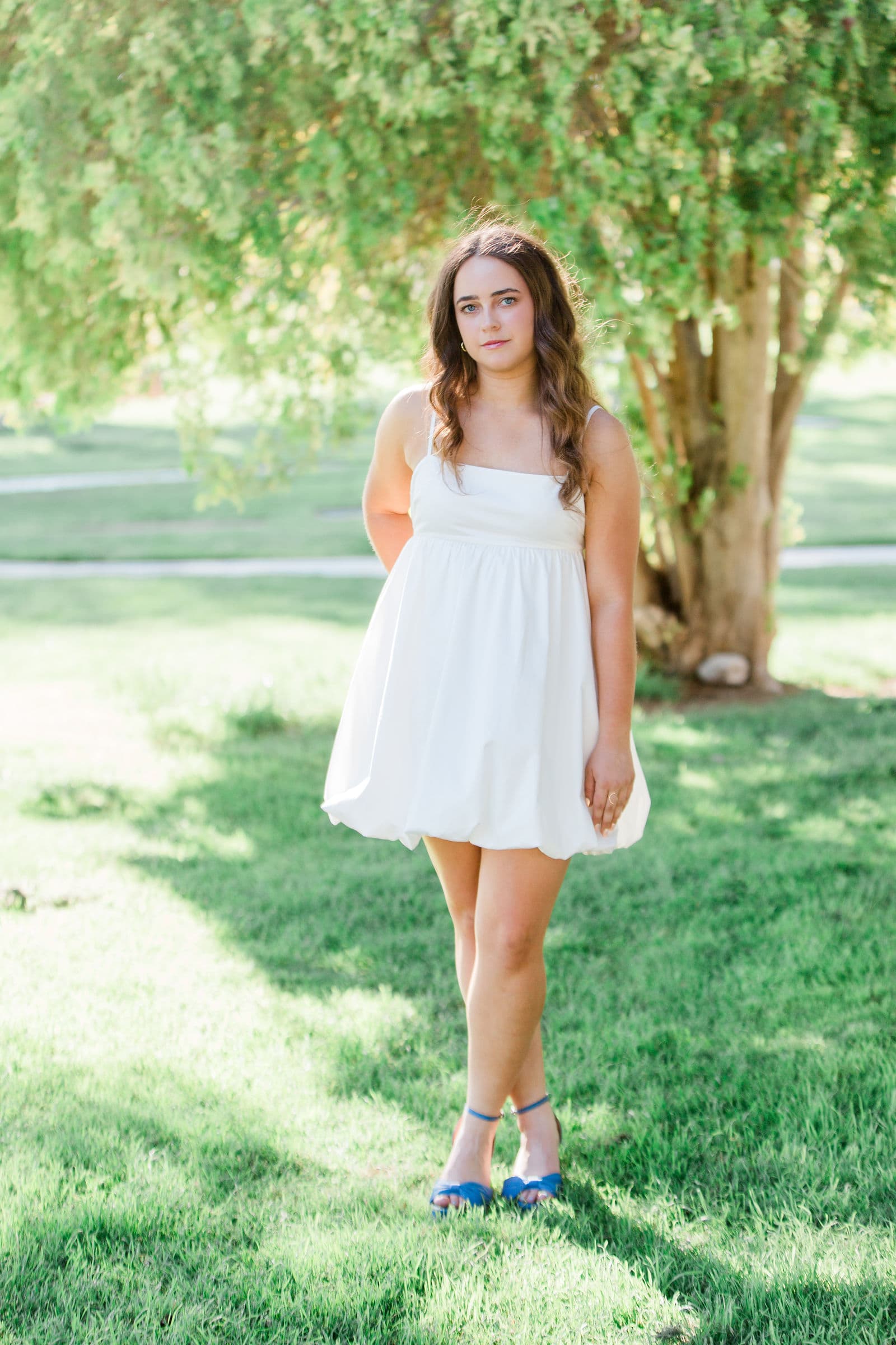 Senior girl white bubble dress in park