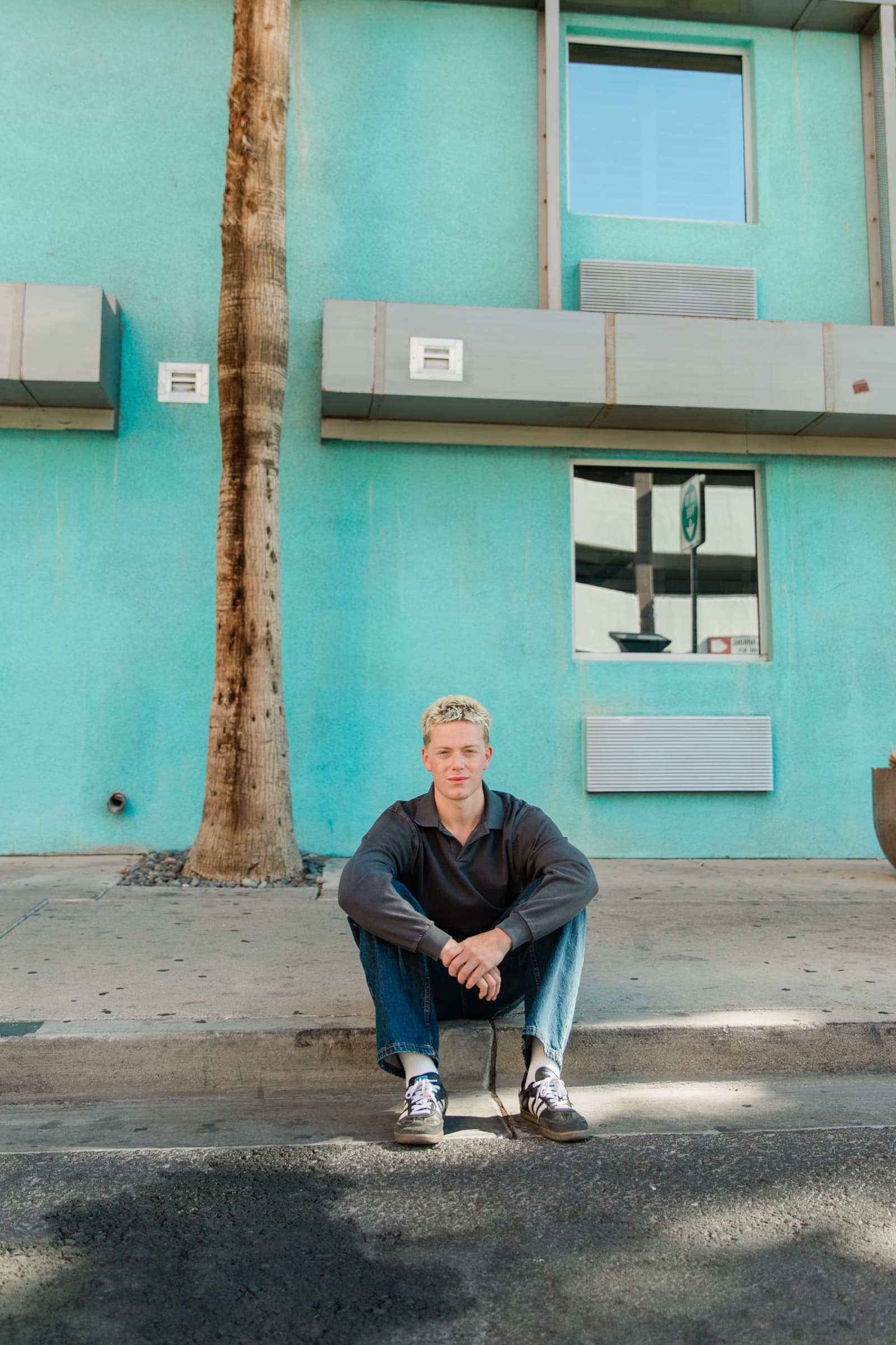 Senior boy on turquoise wall Downtown Las Vegas