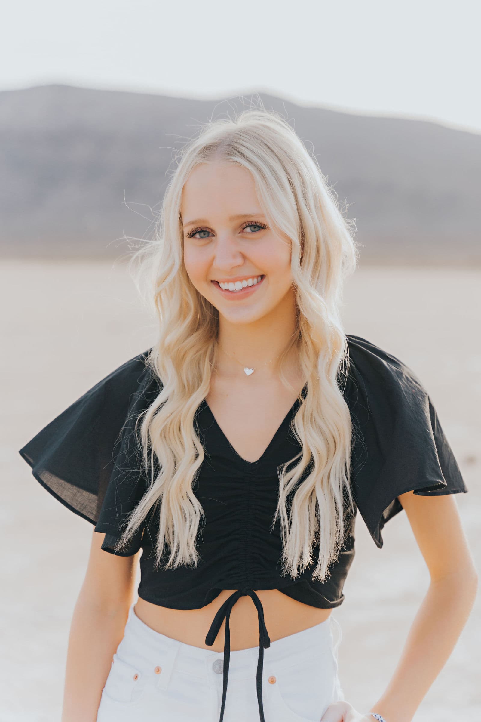 Senior girl black top white shorts close-up Dry Lake