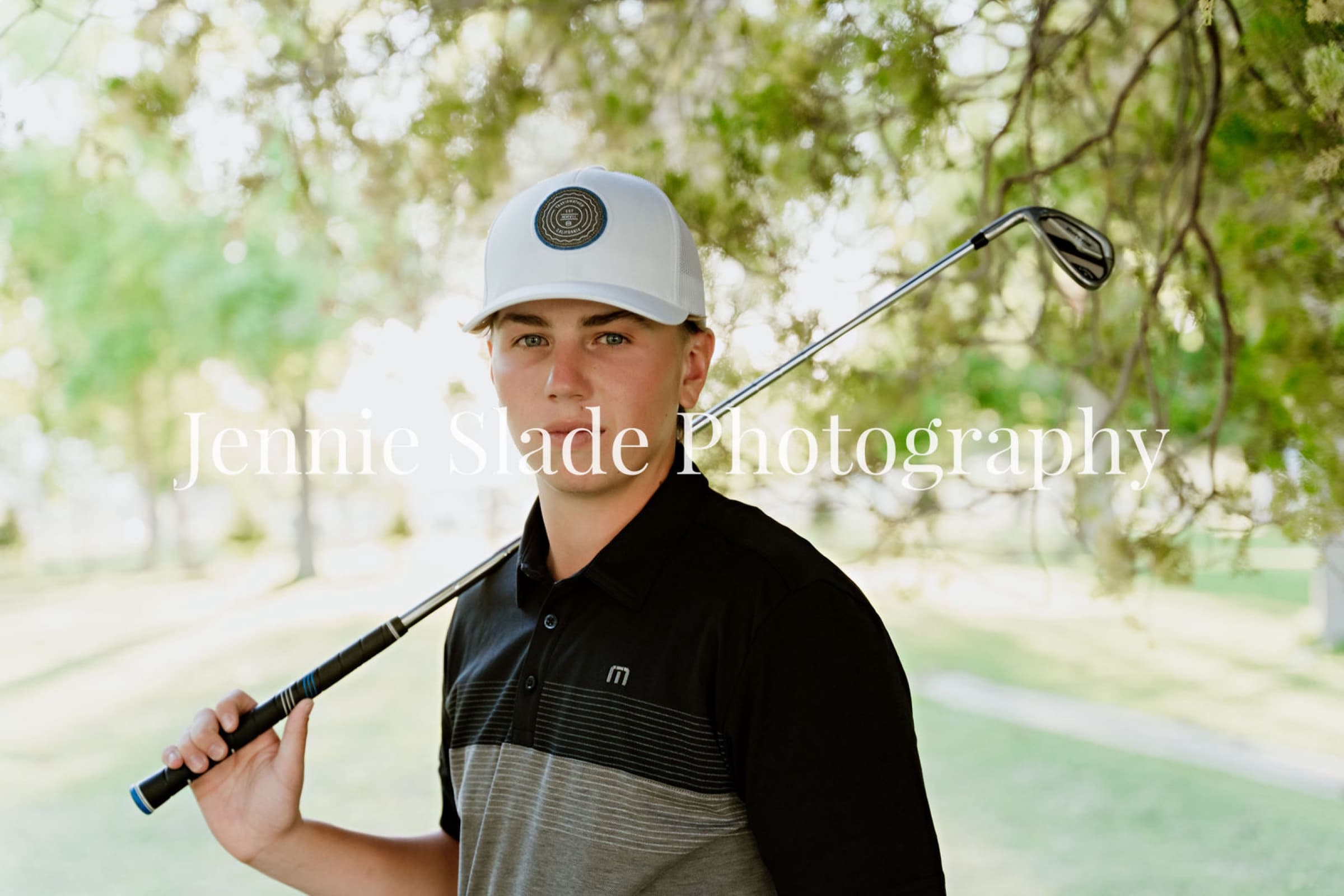 Senior boy with golf club and Travis Mathew polo