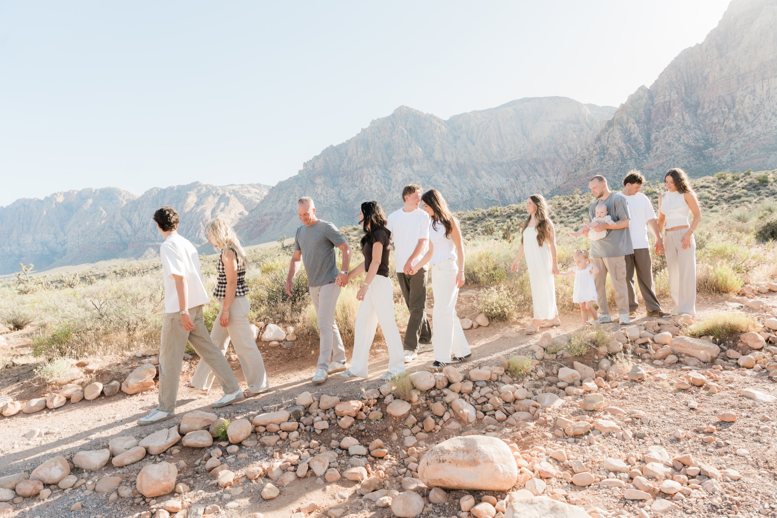 Extended family walking together along a path with Red Rock Canyon behind them, Las Vegas, by Jennie Slade